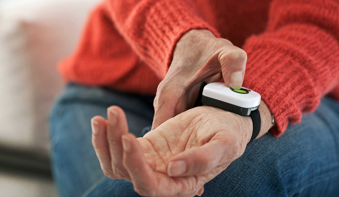 personal masada*alert button being pressed on someone's wrist